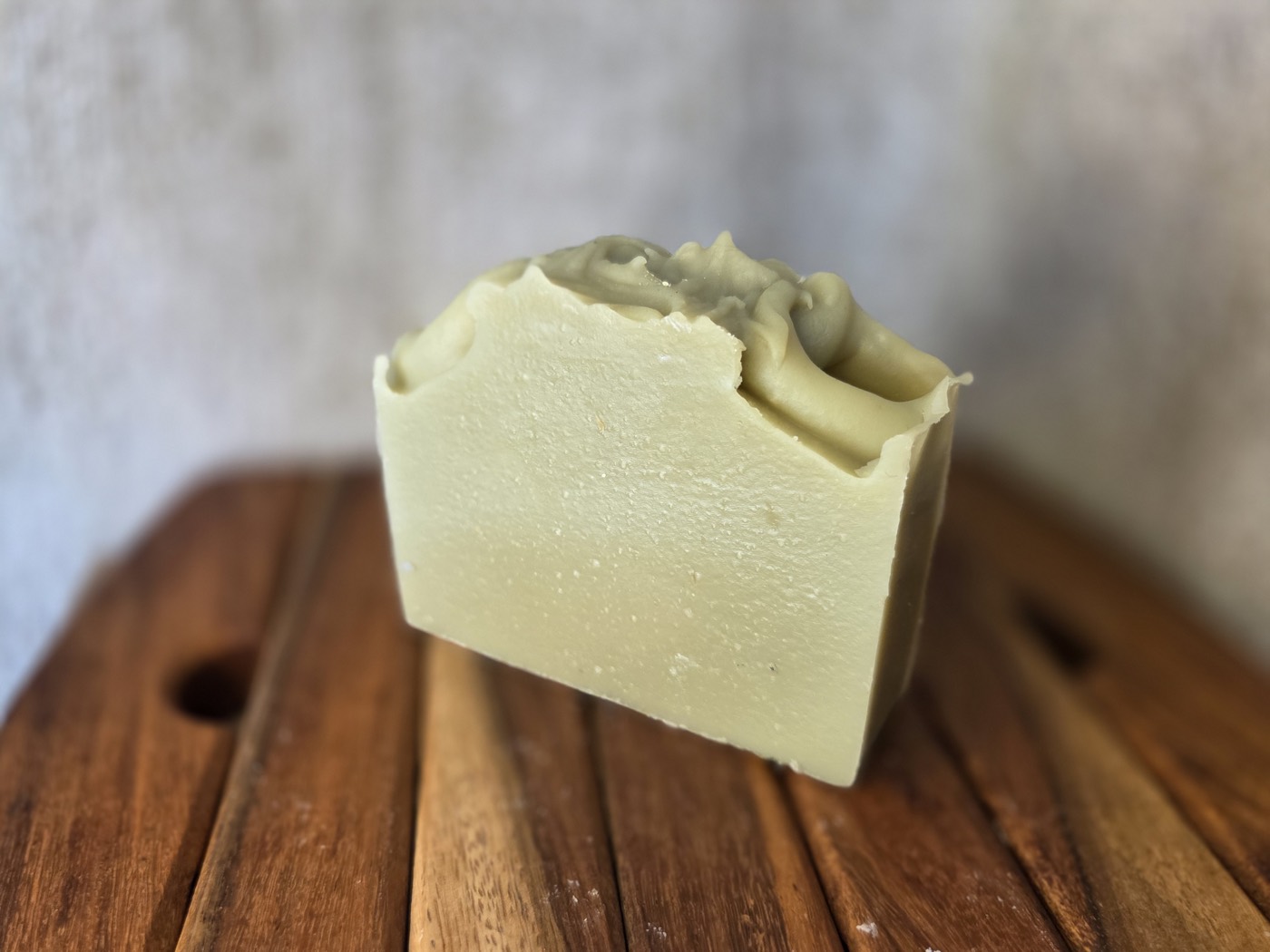 Pale celadon-green soap bar with a piped frosting-like top
