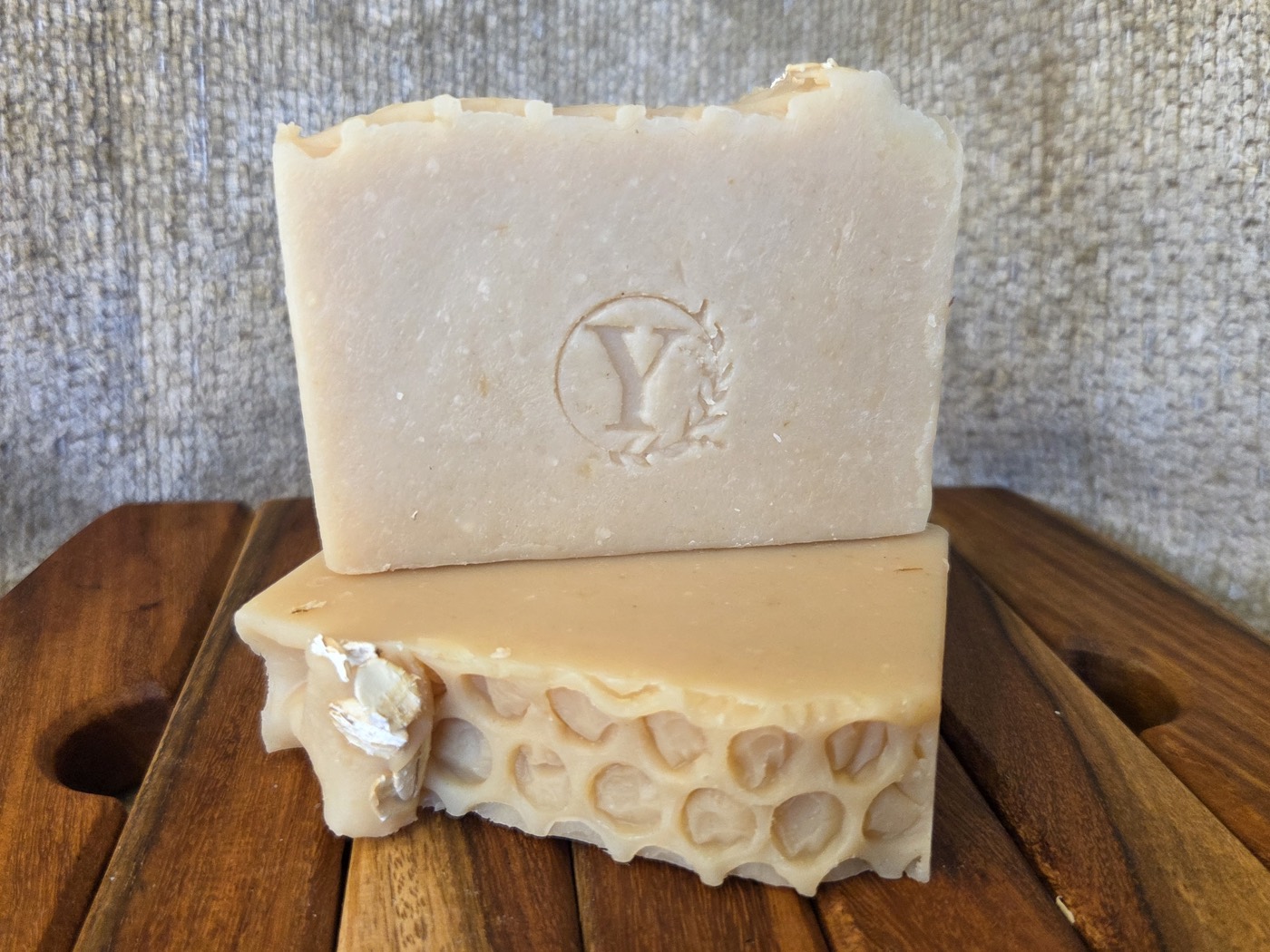 Cream soap bar stamped with a Y, stacked on a honeycomb-textured bar (alternate angle)