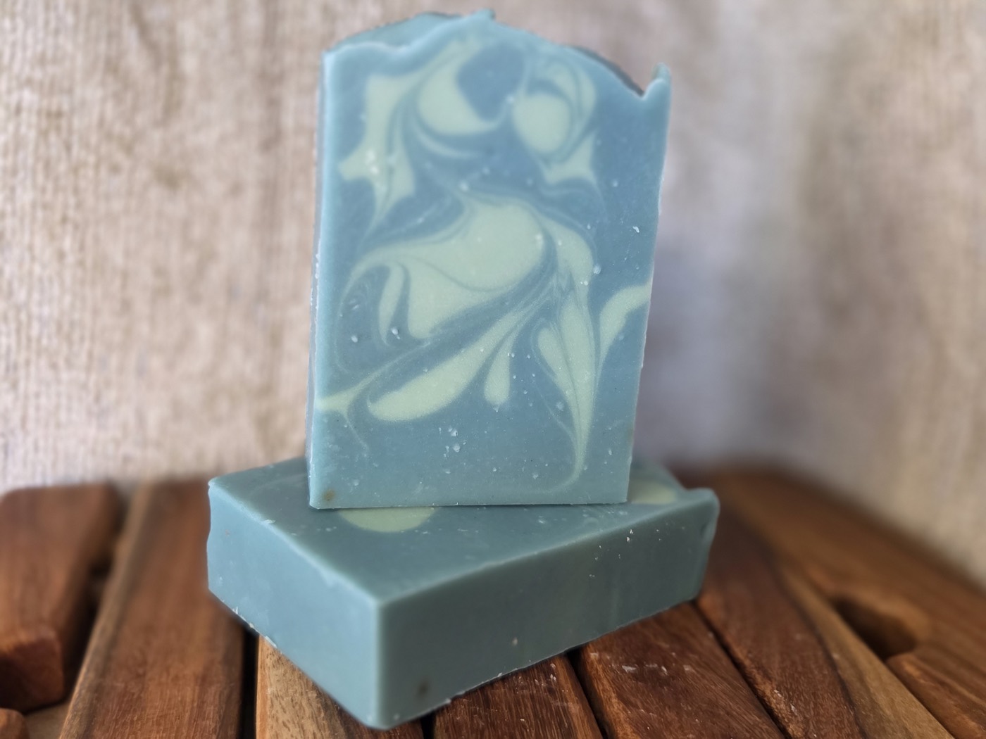 Teal-blue soap bars with cream swirls (alternate angle)