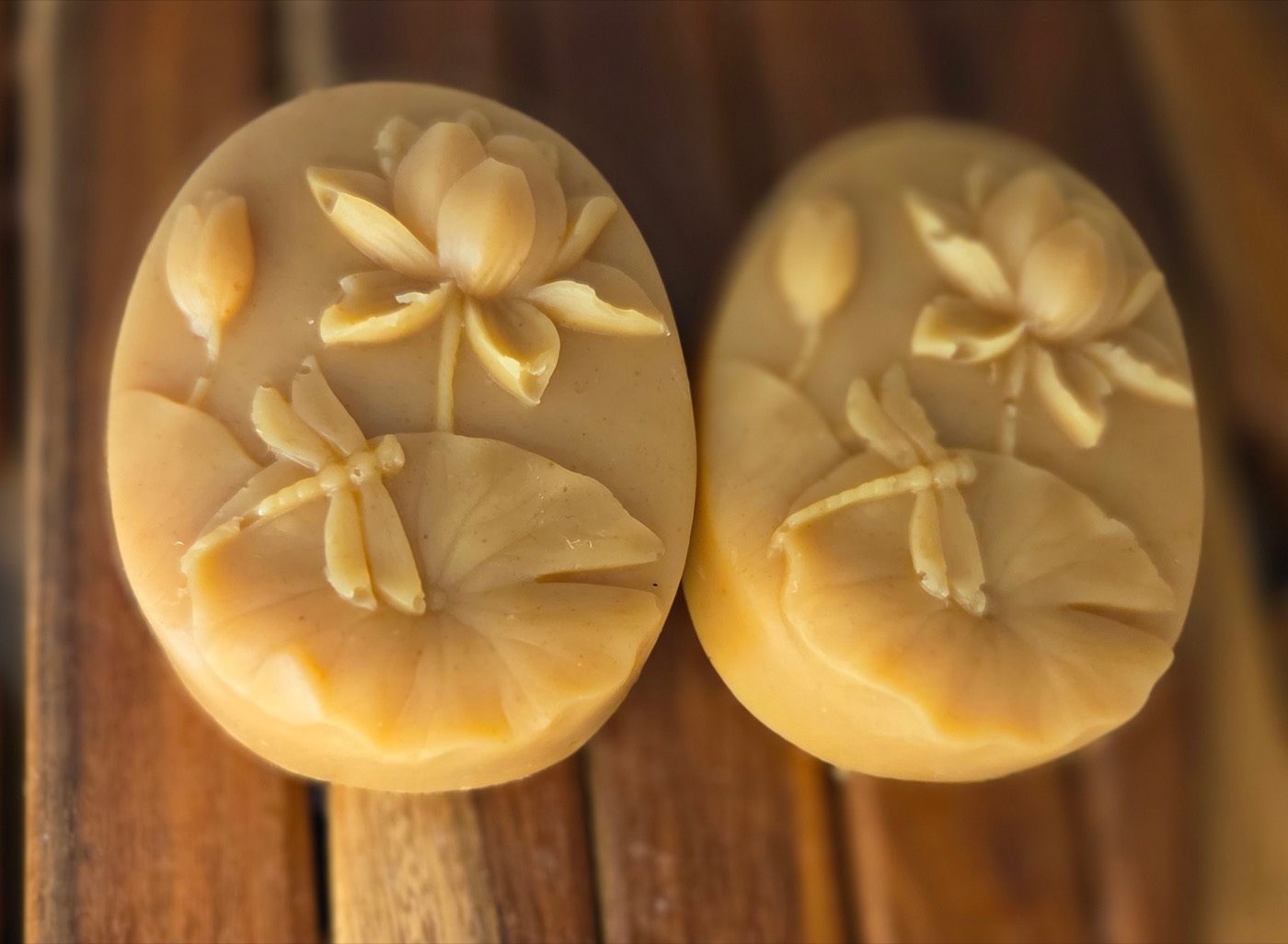 Golden oval soap bars with lotus flower and dragonfly relief (alternate angle)