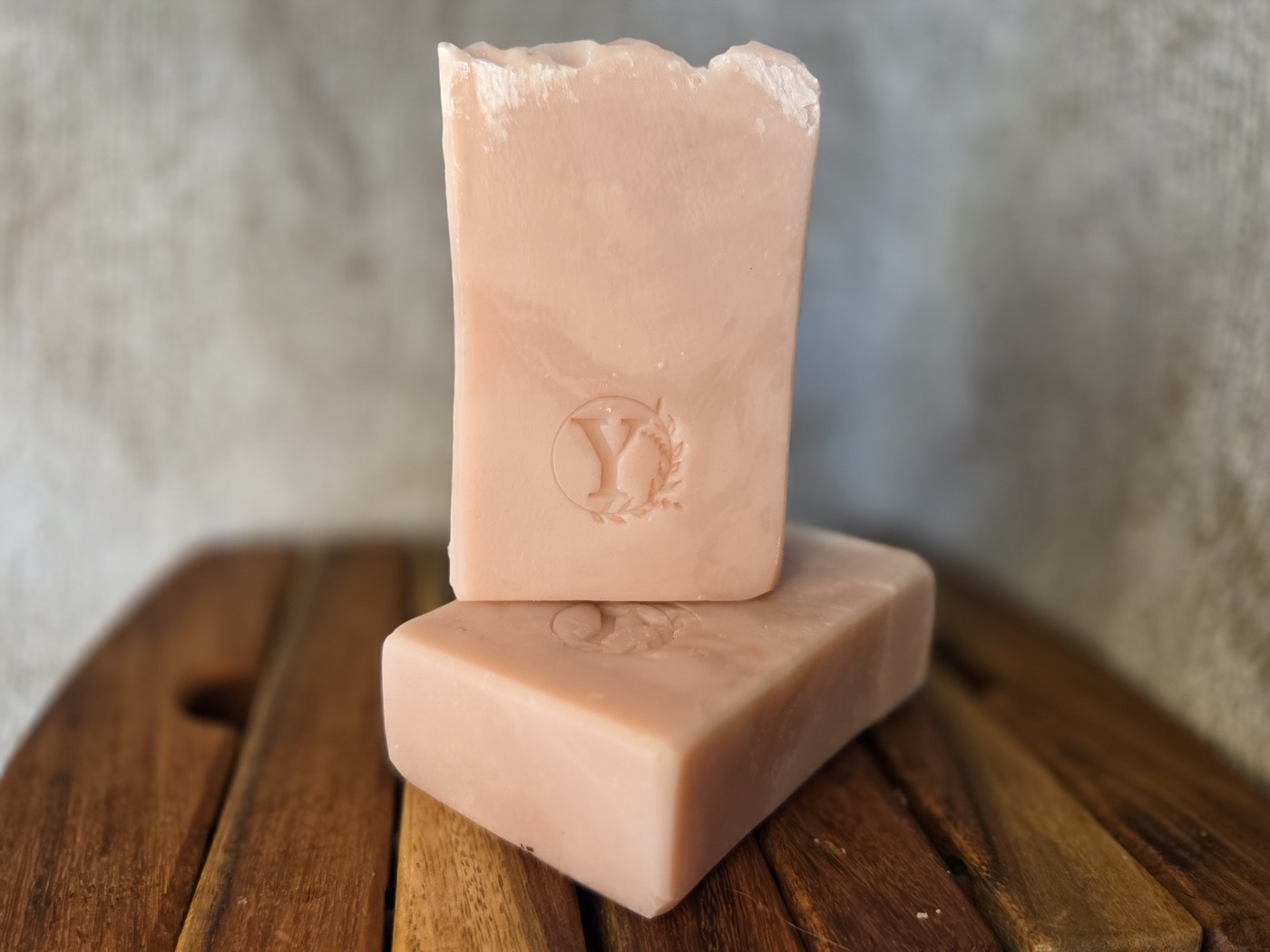 Two soft pink marbled soap bars stamped with a Y (alternate angle)